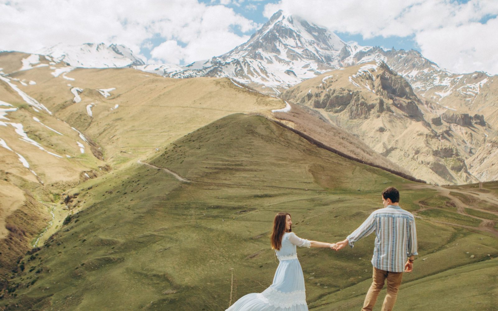 loving couple walks high mountains glaciers peak loving Georgian couple walks in the background of high mountains with glaciers at the peak