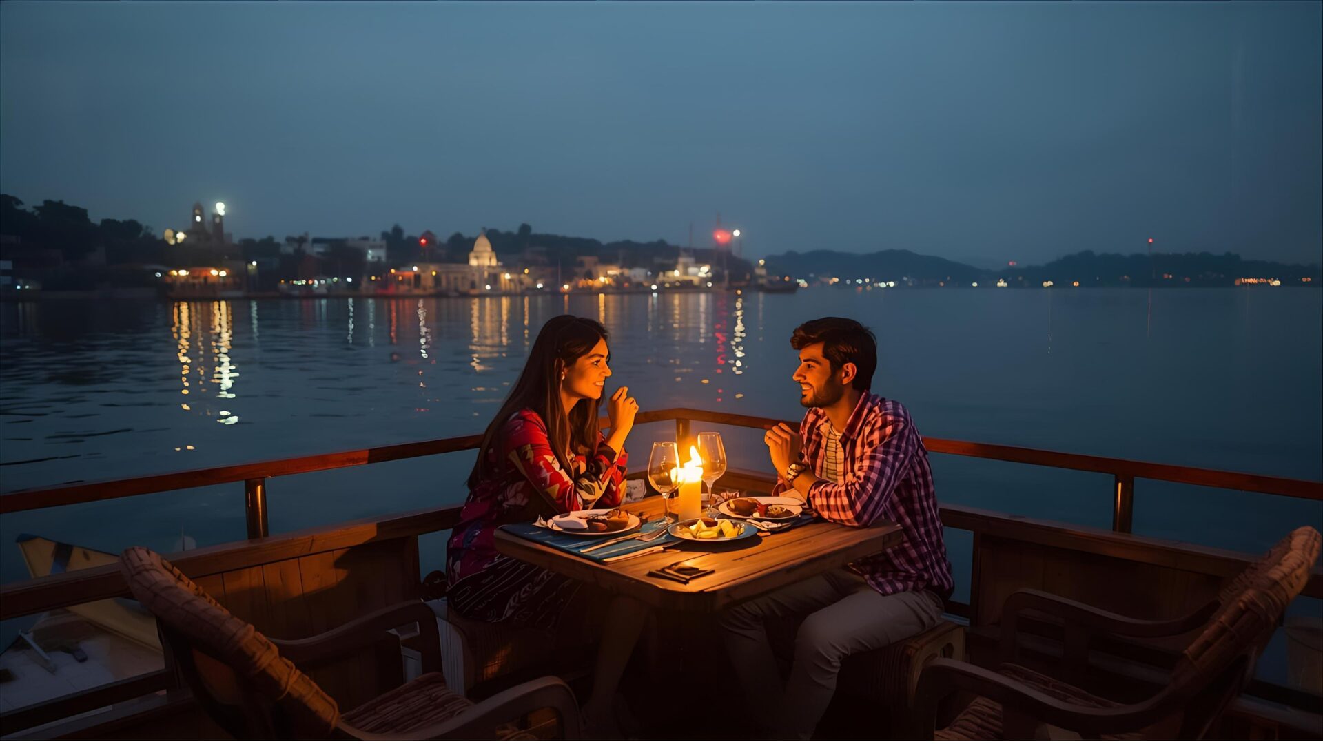 Couple having private candlelit dinner on houseboat deck with Dal Lake in background