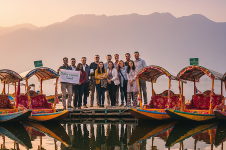 Diverse travel group enjoying their Kashmir group tour package from Delhi with Nature Connect Travels, overlooking Dal Lake and mountains