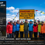 Ladakh group tour packages 2026 - diverse group of happy travelers at Khardung La 18,380 ft, IRCTC ₹49,000-52,900, Travel King India ₹29,500, Trodly ₹15,000-22,000, child discounts 25-35% off