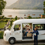 Best Urbania tempo traveller service Srinagar 2026 - happy multi-generational group in premium Tata Urbania Luxury at Nishat Garden overlooking Dal Lake with professional chauffeur