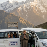 Best cab service for Amarnath Yatra 2026 - white Toyota Innova SUV on Himalayan road with oxygen cylinder and professional driver greeting pilgrims