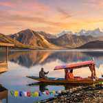Book Kashmir tour package 2026 - sunset on Dal Lake with houseboat and shikara against Zabarwan mountains