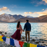 Ladakh honeymoon package for couple 2026 - romantic couple at Pangong Lake sunset with turquoise waters and snow-capped mountains