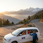 SUV taxi for Amarnath Yatra 2026 - Toyota Innova on Himalayan road to Baltal base camp with professional driver and happy multi-generational pilgrim family