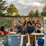 Urbania for group travel Kashmir 2026 - multi-generational happy family seated in premium leather captain seats inside Tata Urbania Luxury overlooking Lidder River valley Pahalgam