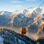 Gulmarg cable car booking 2026 - Gondola ascending above snow-covered Himalayas