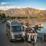 Luxury tempo traveller Srinagar 2026 - Urbania group tour vehicle on Dal Lake with happy travelers