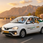 White Toyota Etios sedan cab on Srinagar's Boulevard Road with Dal Lake, houseboats, and Zabarwan mountains - sedan cab service Kashmir for comfortable family travel