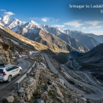 Srinagar to Ladakh taxi booking - SUV driving through Zojila Pass Himalayan mountains