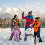 Budget Kashmir winter package for family showing parents and children playing in snow at Gulmarg meadow