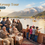 Kashmir group tour - multi-generational group on Dal Lake houseboat deck with shikaras and Zabarwan mountains in background