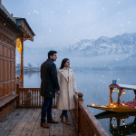 Kashmir honeymoon packages in winter by Nature Connect Travels showing couple on snow-covered houseboat deck