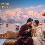 Kashmir snowfall honeymoon package - couple in pherans on snow-dusted houseboat deck with Dal Lake and Pir Panjal sunset