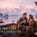 Kashmir trip cost for couple in winter - couple in pherans on snow-dusted houseboat deck with Dal Lake and Pir Panjal sunset