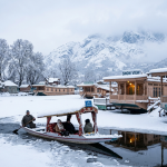 Kashmir trip package in February by Nature Connect Travels showing snow-covered Dal Lake houseboats and Shikara
