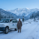 Kashmir winter cab service with snow chains fitted on 4x4 vehicle on Tangmarg Gulmarg snow road