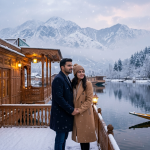 Kashmir winter couple packages from Pune by Nature Connect Travels showing couple on snow-covered houseboat deck