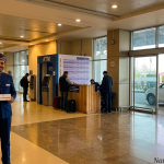 Srinagar prepaid taxi counter at airport arrivals with Nature Connect Travels chauffeur holding name placard