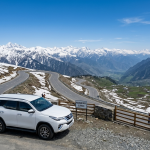 Srinagar to Gurez Valley SUV cab fare showing Fortuner at Razdan Pass with Himalayan mountain views